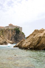 Sticker - vertical view of Dubrovnik's old town walls perched on a cliff above the Adriatic Sea in Croatia