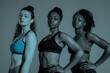 © anzodesign - Three women of diverse body shapes posing confidently in athletic wear during studio session