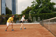 © prostooleh - Tennis players playing a match on the court on a sunny day
