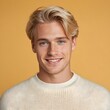 © Adam - Portrait of a smiling man with blonde hair, white teeth, and blue eyes, wearing a white sweater. Cheerful and handsome guy on an isolated background.
