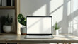 © Santy Hong - Minimalist workspace with a laptop on a desk, blank screen for your content, bright and airy environment