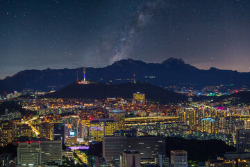 Wall Mural - Seoul city skyline and skyscrapers at night with Namsan Mountain and Bukhansan in the background, Seoul, South Korea.