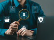© MrPanya - (KYC) Businessman holding magnifying glass and identity verification symbol to increase financial security and access personal financial information. Biometric security. Know your customer concept.