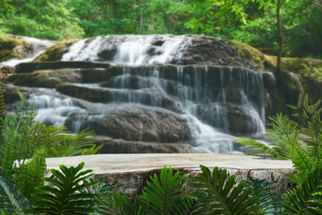 Wall Mural - Wood table top podium in outdoor waterfall green tropical forest nature background.Organic natural water product present placement pedestal counter display, spring summer jungle paradise concept.