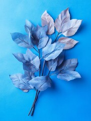 Poster - Blue Leaves on Blue Background - Minimalist Nature Photography - A minimalist composition featuring a sprig of blue leaves against a vibrant blue backdrop, symbolizing tranquility, serenity, nature, s