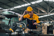 © anusak - Caucasian engineer using a laptop in a factory. man working in plastics factory.