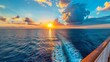 © Drew - Back view of ship with sunset and ocean waves behind