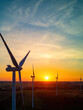 © Robert - Wind turbines in a field just before sunrise, representing the concept of renewable energy and sustainability.