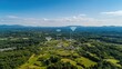 © lililia - A picturesque village nestled in the mountains showcases homes connected by a network of wireless signals amid lush greenery