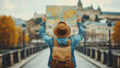 © mimi - A traveler with a backpack and hat holds up a map while exploring a picturesque European city, symbolizing adventure and discovery during a journey.