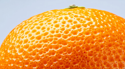 Wall Mural - Macro shot of the texture of a ripe oranges skin showing the bright orange surface with detailed pores 