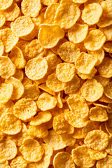 Wall Mural - macro shot of the texture of cornflakes showcasing the golden crispy flakes with intricate patterns