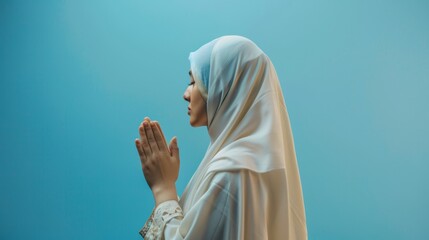 Back portrait of young Asian Muslim woman wearing ihram praying with hand gesture