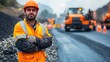 © talkative.studio - Construction Worker in Orange Safety Vest and Hard Hat Stands on Road