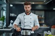 © Jullia - Handsome Professional Chef Cooking in a Modern Restaurant Kitchen