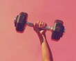 © adilun - A strong hand lifting a black dumbbell against a vibrant pink background, showcasing fitness and strength training.