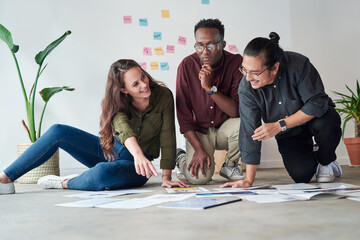 Poster - Business people, talk and teamwork in creative office, paper and brainstorming at public relations agency. Employees, floor and documents for campaign planning, speaking and review market research