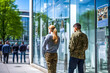 © Garnar - Veterans in uniform stand attentively at a job board in modern building with career fair inside. Concept of former military service members seeking employment and social reintegration after service