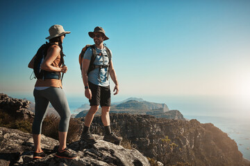 Canvas Print - Hiking, vacation and couple on mountain with backpack for adventure, cliff trekking and fitness. Travel, nature trail and people for wellness and exercise achievement on workout, holiday or journey