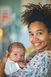 © GraysonStock - A young African-American woman lying in bed in a delivery room with a baby in her arms, smiling and looking at the camera.