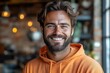 © furyon - charismatic bearded man in tangerine hoodie genuine smile twinkling eyes urban loft backdrop warm ambient lighting