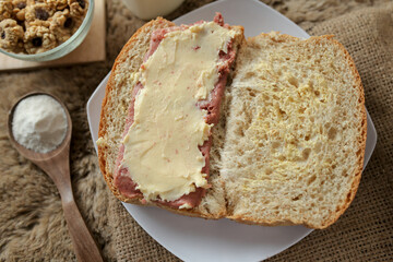 Bread with smoked beef and mozarella cheese on a plate for fast food breakfast or coffee break.	
