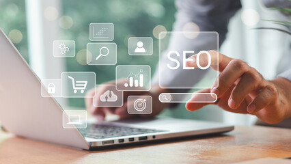 Wall Mural - businessman using a computer for analysis seo search engine optimization marketing ranking traffic w