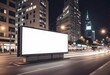 © Anyket - A large blank billboard in the middle of a city street at night, with blurred traffic and buildings in the background