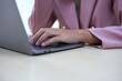 © kiattisak - Successful Asian businesswoman sitting at desk working using laptop computer in office. Business and people concept. Businesswoman using laptop computer and working with documents.