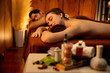 © InfiniteFlow - Caucasian couple customer enjoying relaxing anti-stress spa massage and pampering with beauty skin recreation leisure in warm candle lighting ambient salon spa at luxury resort or hotel. Quiescent