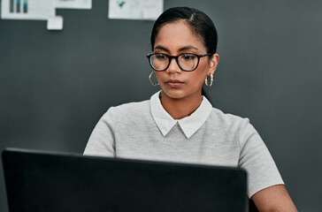 Wall Mural - Glasses, businesswoman and laptop in office for reading, research and online information for publication. Creative agency, journalist and working on computer for political story, article and editing