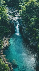 Poster - Aerial view of a waterfall cascading into a turquoise lagoon.