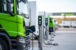 © Robert Kneschke - Electric truck charging at biogas station showcasing sustainable transportation solutions