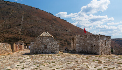 Wall Mural - Porto Palermo, Albania - 6 September 2021: Old fortress in Porto Palermo in Albania and Albanian flag