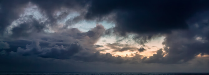 Wall Mural - Dramatic Colorful Sunrise Sky over North Atlantic Ocean. Cloudscape Nature Background. Panorama