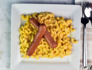 Wall Mural - two hot dogs  on macaroni and cheese