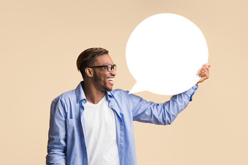 Poster - Opinion. Happy Afro Guy Holding Blank White Speech Bubble Showing What He Thinks Standing Over Yellow Studio Background. Mockup