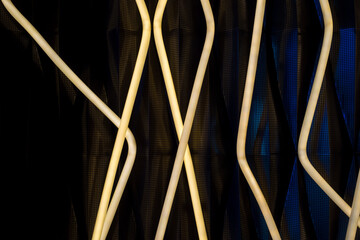 Modern abstract art installation featuring intertwined white light tubes against a dark background. Perfect for use in contemporary design, architecture presentations, and creative projects.