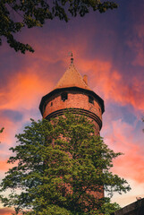 Wall Mural - Haunted abandoned tower on the sunset sky background