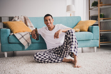 Sticker - Photo of attractive funny guy nightwear pajama watch football enjoying weekend couch drink alcohol indoors room home house