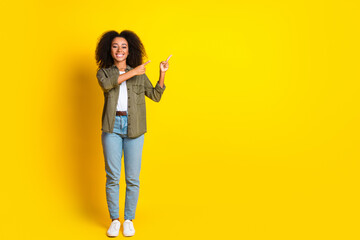 Sticker - Full size photo of lovely girl with perming coiffure wear khaki shirt directing at sale empty space isolated on yellow color background