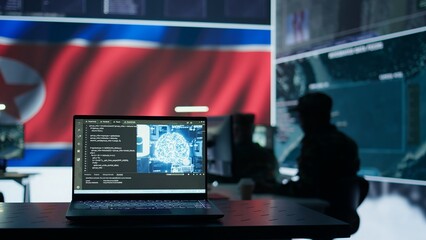 Military personnel working next to AI brain neural network in a command post with a North Korea flag on big screen. IT engineer employing deep learning to spread misinformation for scams. Camera B.