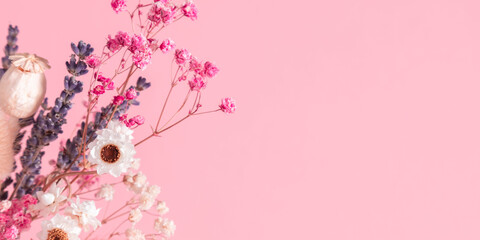 Wall Mural - top view of beautiful bouquet of different dried flowers on pastel pink background with copy space. 