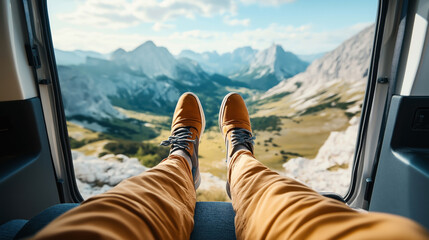 Poster - Person with brown shoes resting inside a vehicle, overlooking a scenic mountain landscape through the open door.