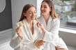 © Pixel-Shot - Young lesbian couple doing makeup in bathroom