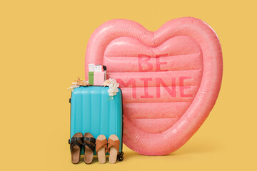 Canvas Print - Packed suitcase, shoes and inflatable mattress in shape of heart with text BE MINE on yellow background