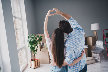 Wall Mural - Rear portrait of two young people cuddle show heart symbol relocating moving box package new apartment indoors