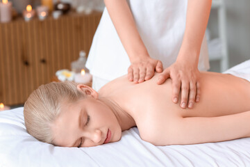 Poster - Young woman having relaxing massage in spa salon