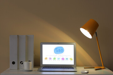 Sticker - Workplace with modern laptop, cup and glowing lamp in stylish office at evening. SEO concept