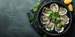 © Prostock-studio - A platter of freshly shucked oysters garnished with mint and lemon wedges invites an elegant seafood experience.